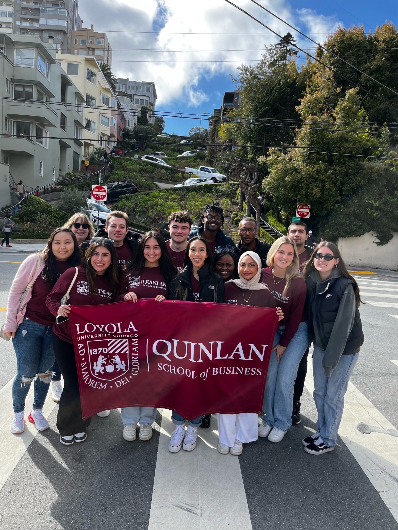 A group of students pose in front of the famous Lombard Street in San Francisco.